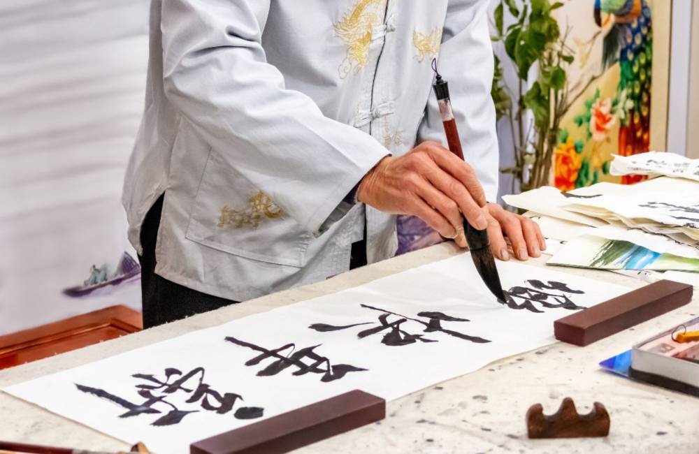 Homme dessine une calligraphie